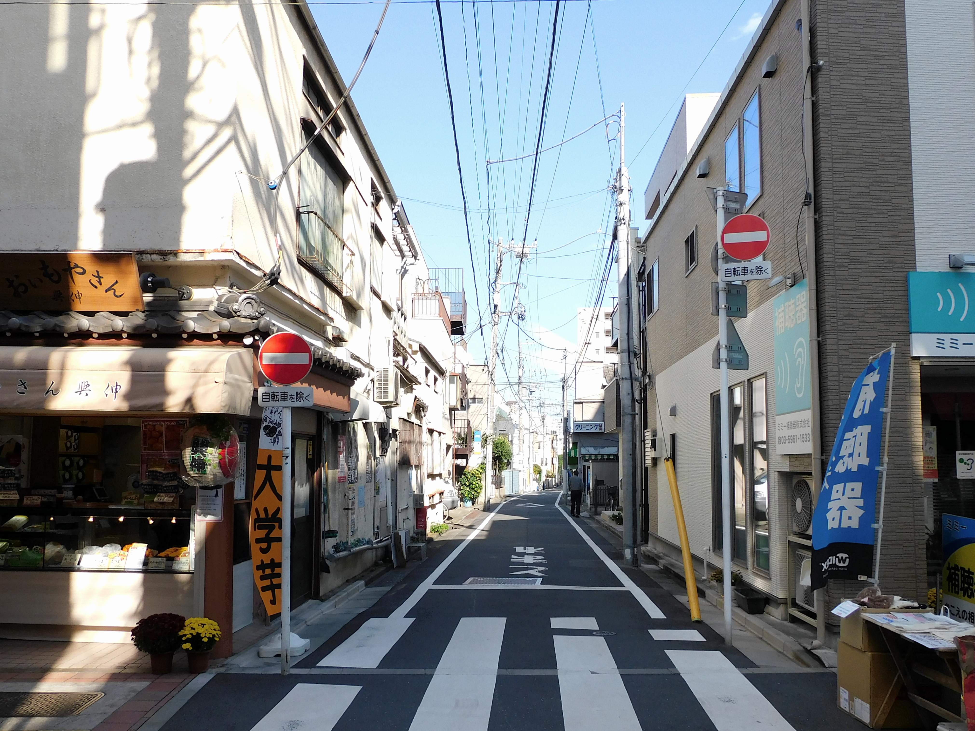 Quiet Japanese backstreet showing everyday architecture and street life